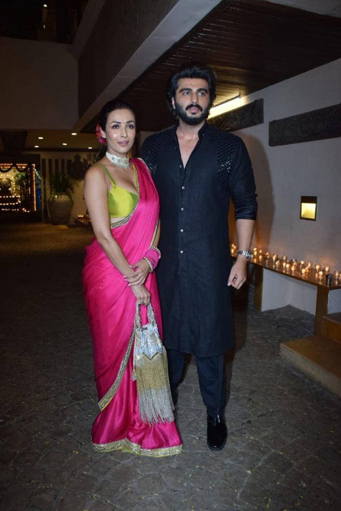 Malaika Arora was stunning in a hot pink sari paired with a lime yellow blouse. The actress wore a statement choker and carried a golden handbag.
