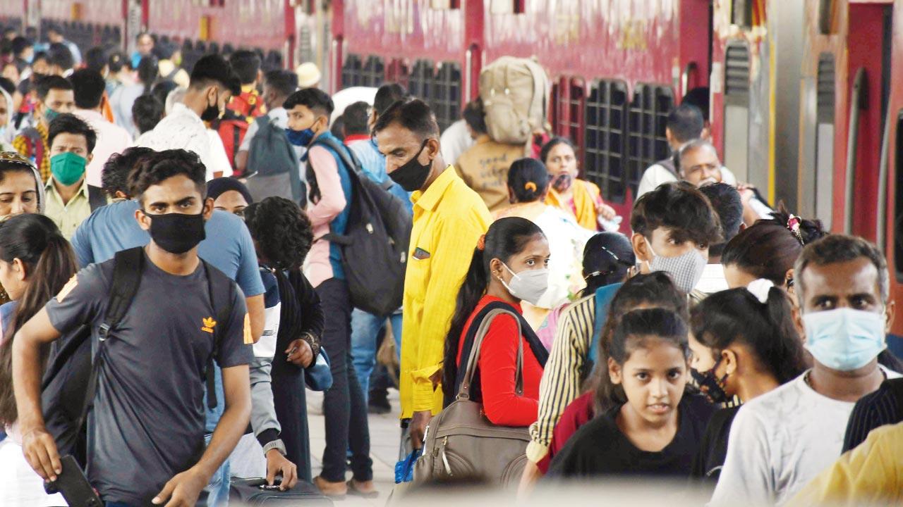 Passengers wait for COVID-19 health screening at Dadar station, on Tuesday. Pic/Ashish Raje