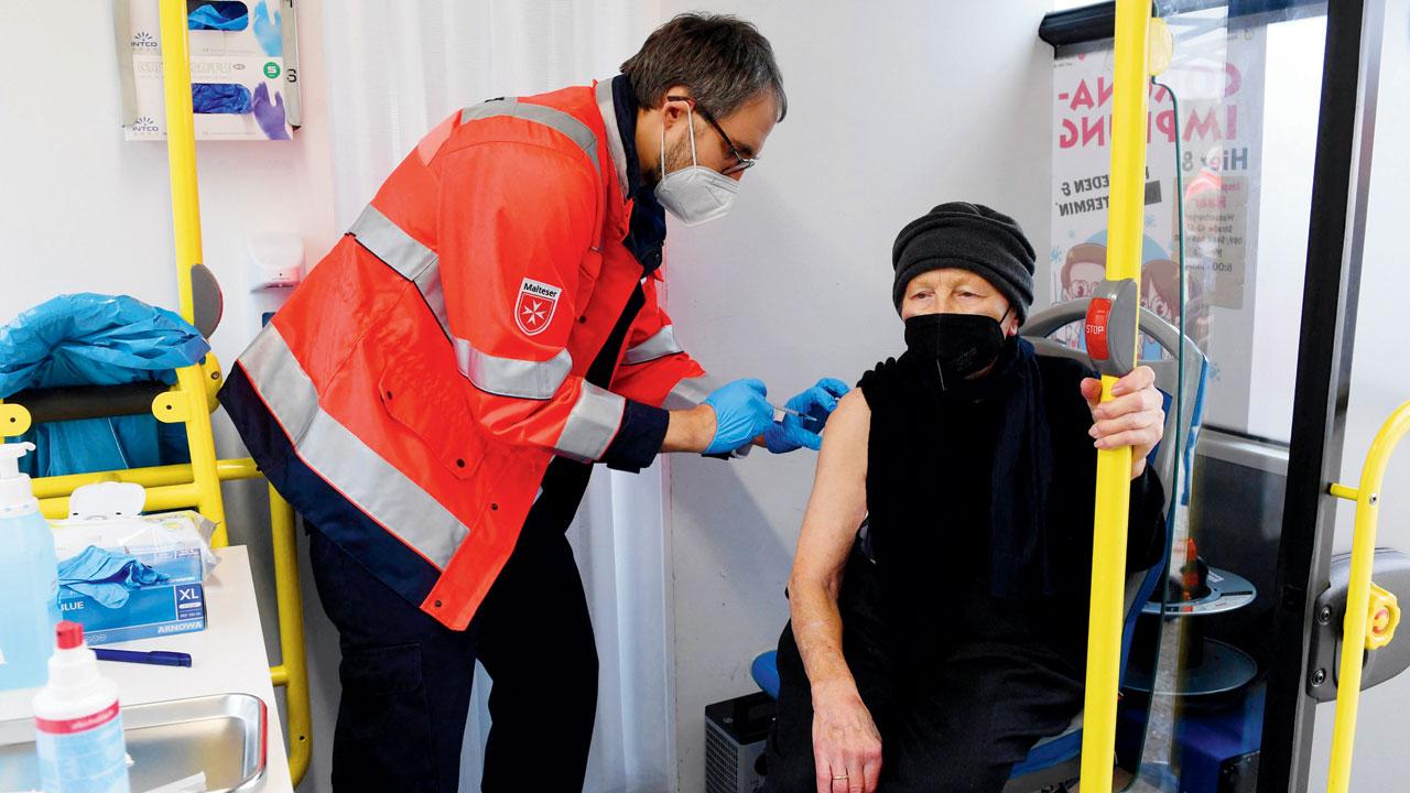 A doctor vaccinates an elderly woman in a vaccination bus in the small village of Unterschleissheim near Munich on Friday. Pic/AFP