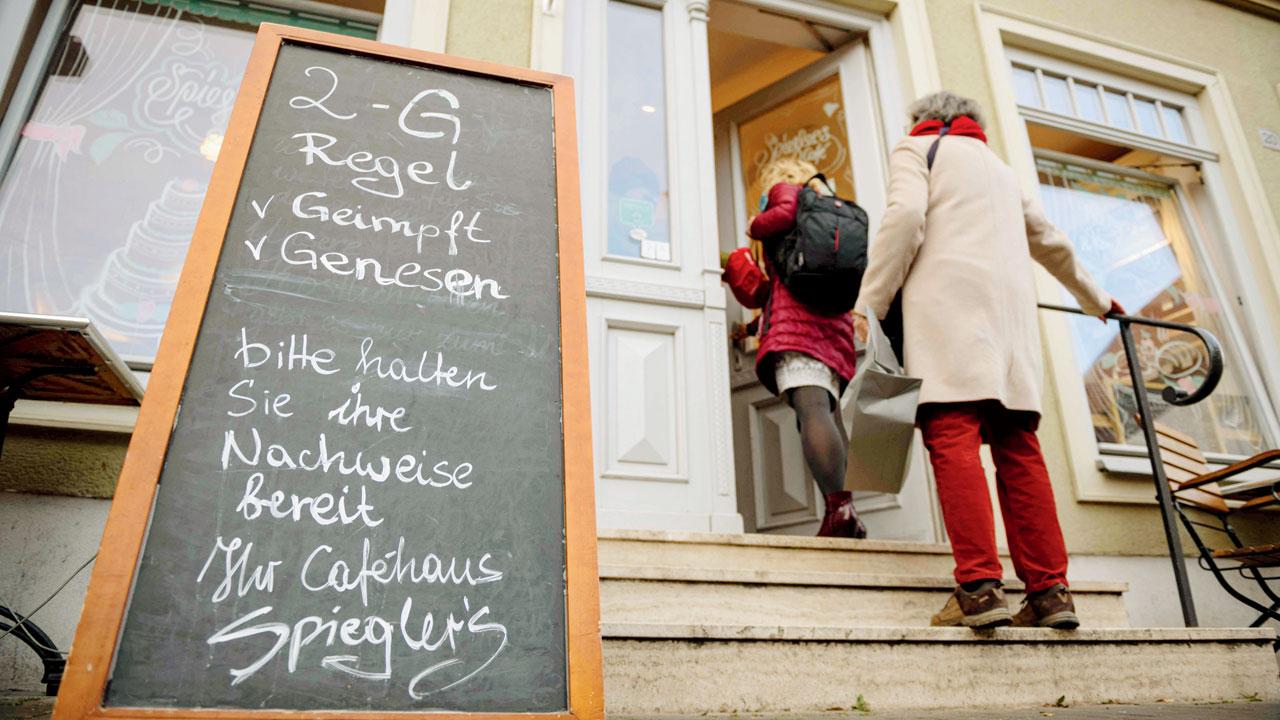 A 2G rule note (vaccinated or recovered) outside a cafe in Erfurt, eastern Germany on Thursday. Pics/AFP