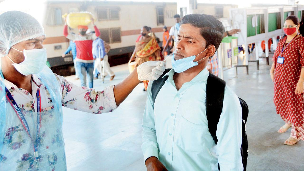 A health worker tests a passenger at LTT on Tuesday. Pic/Sayyed Sameer Abedi