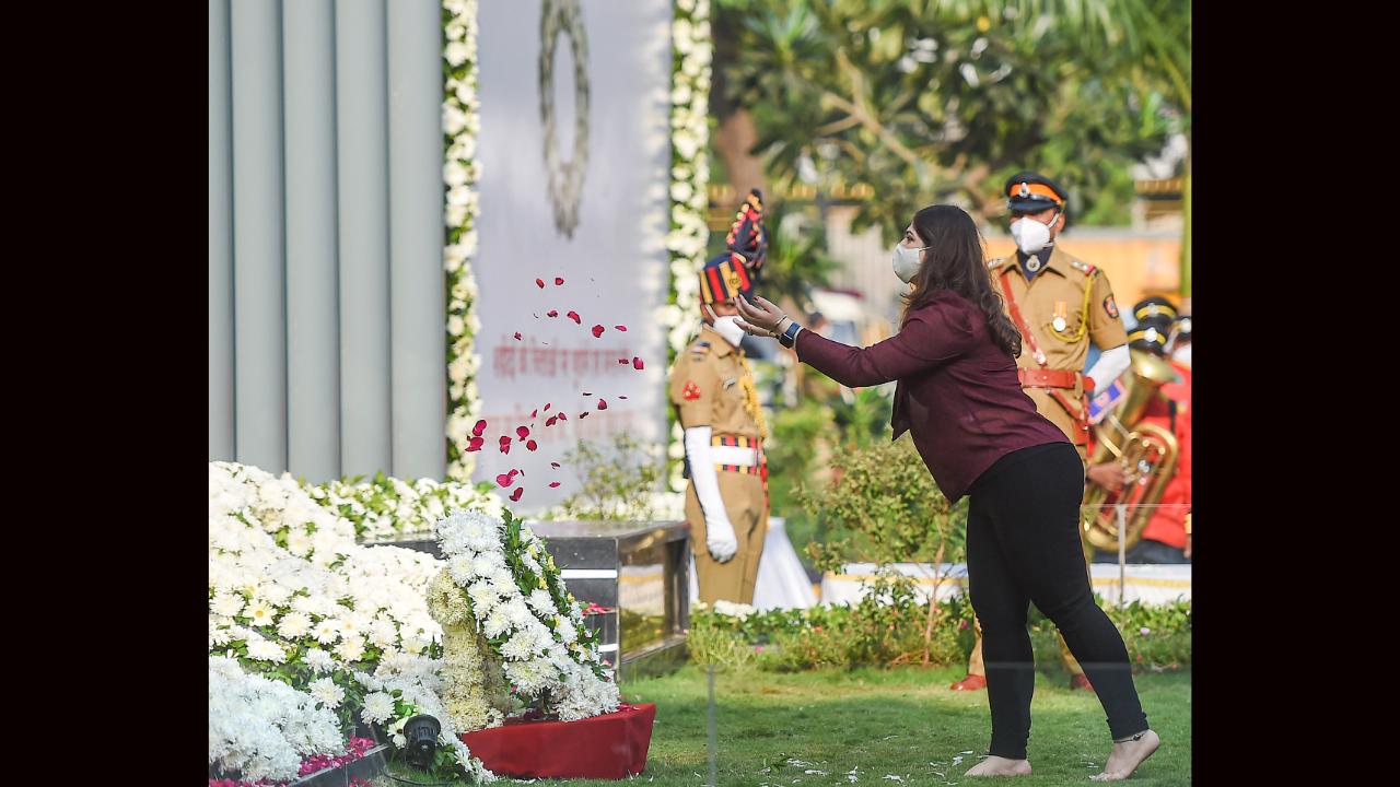 The still-grieving family members, relatives of the martyrs and several bravehearts, including the widows, mothers, sons, daughters, brothers or sisters, also stepped upto the memorial and offered their own personal tributes with flowers or tears for their departed near and beloved ones.  Divya, daughter of late police inspector Vijay Salaskar, pays tribute at the Police Martyrs Memorial. File pic/PTI