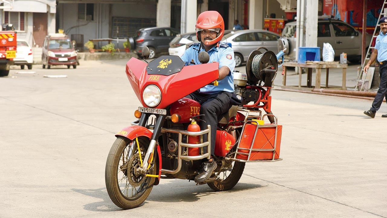 A fire brigade official rides the fire bike on Monday