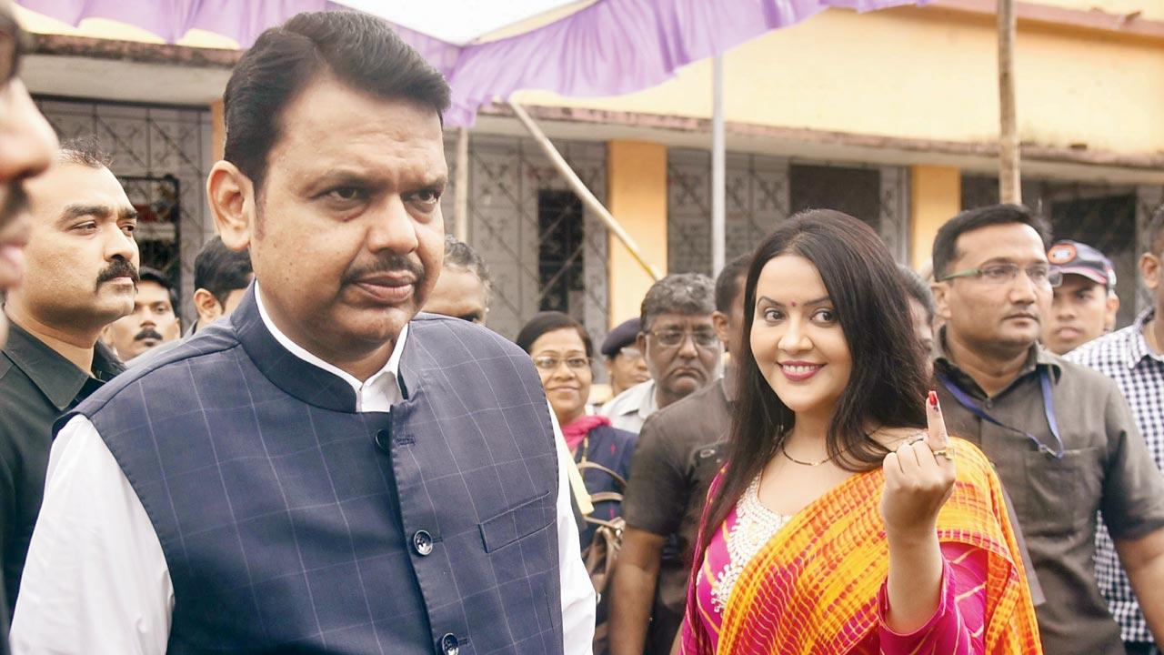 Devendra Fadnavis  and his wife, pictured here after voting, has been targeted because Nawab Malik could not target him. File pic/Pradeep Dhivar