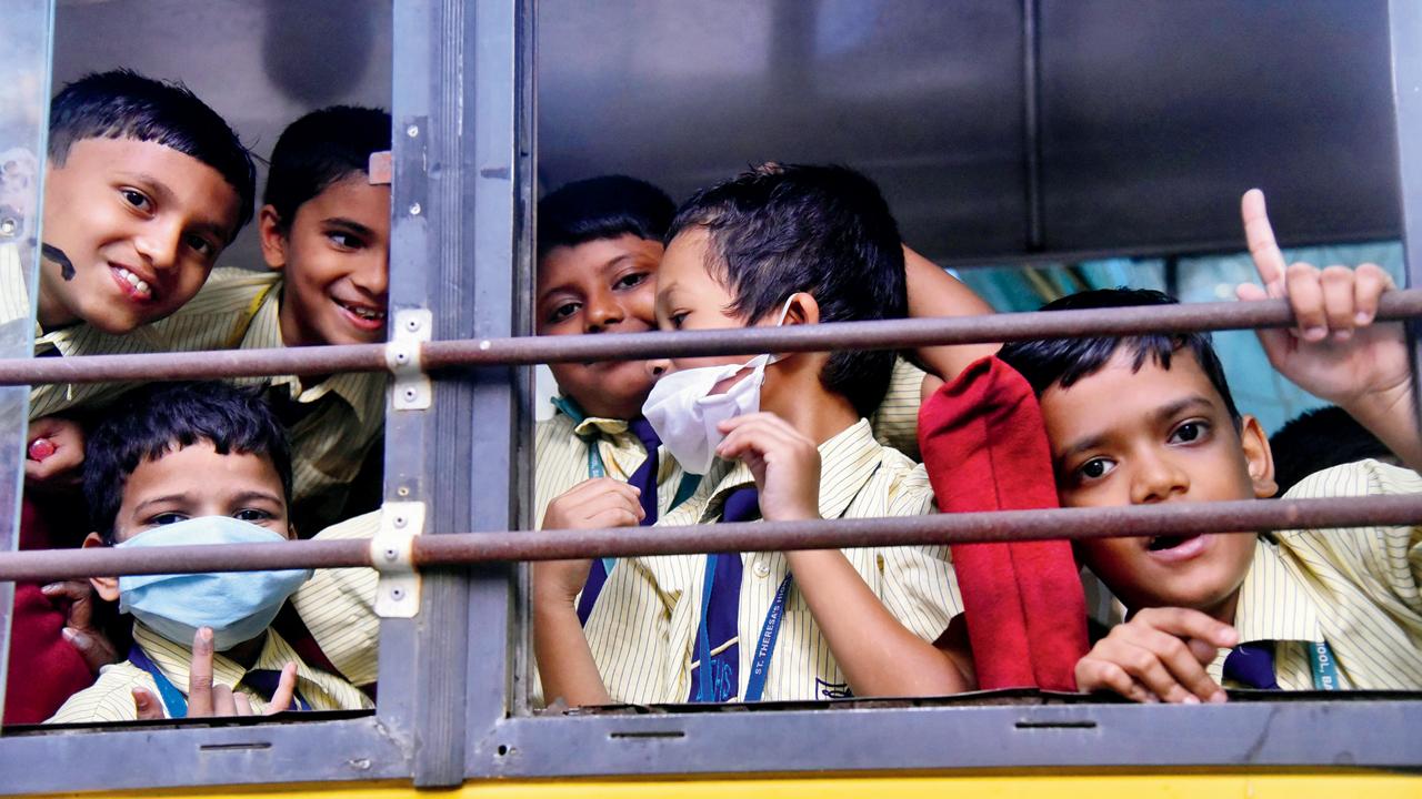 Students in face masks on a school bus, at Bandra, in March 2020. Pic/Pradeep Dhivar