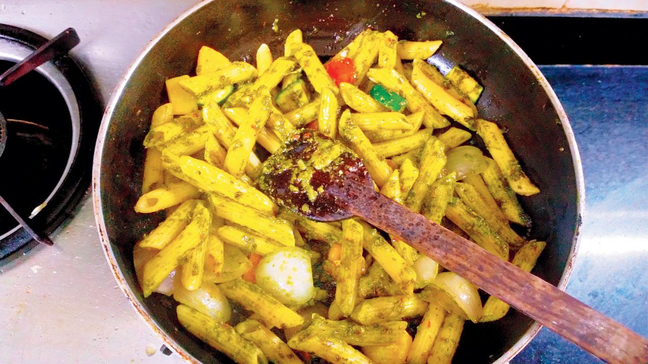 Pesto pasta being cooked