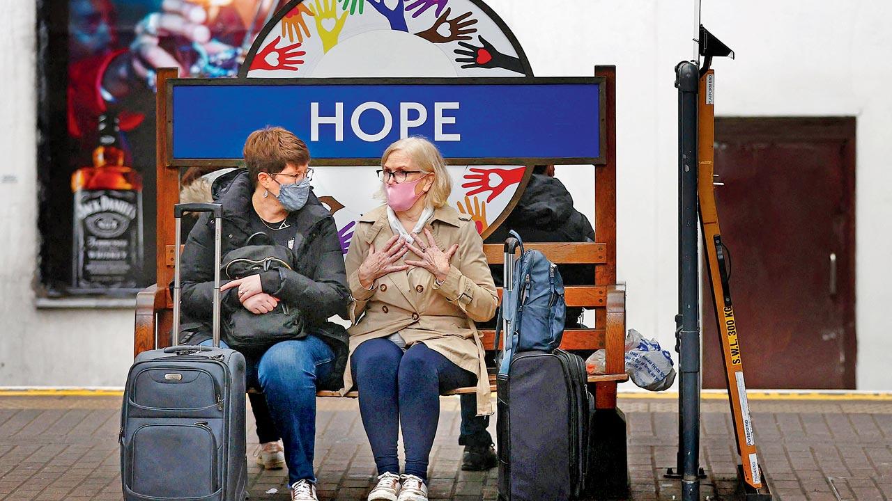 Passengers wait for a train at Hammersmith underground station in London. Britain has made masks compulsory on public transport and in shops. Pic/AFP