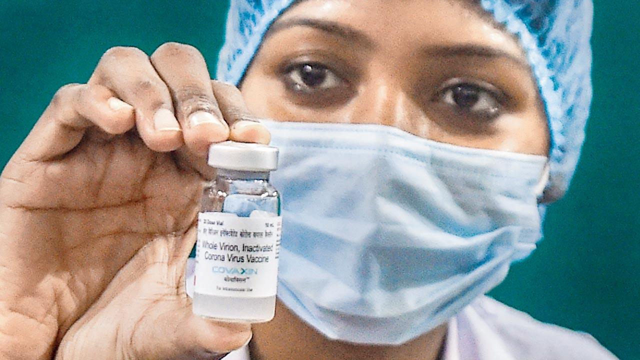 A medic shows a Covaxin vial, at a government hospital, in Kolkata. File pic/PTI