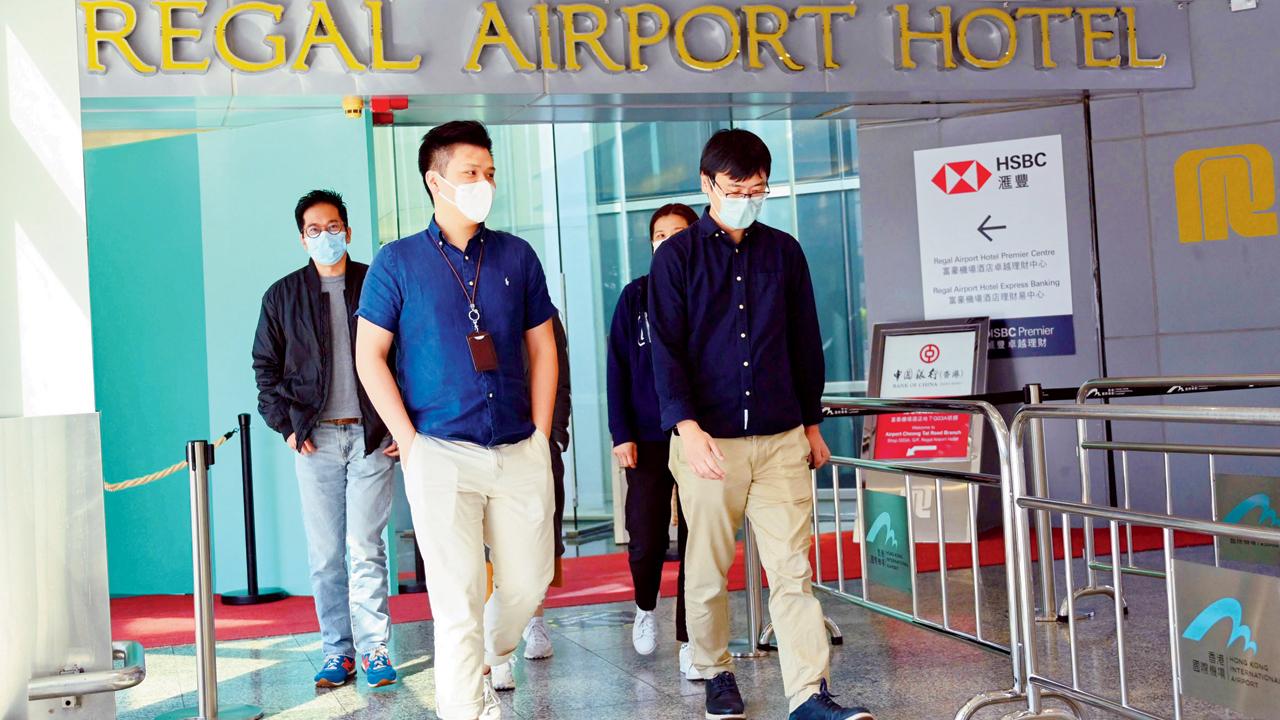 People leave the Regal Airport Hotel at Chek Lap Kok airport in Hong Kong on Friday, where the new variant ‘was detected in a traveller from South Africa and who has since passed it on to a local man. Pic/AFP