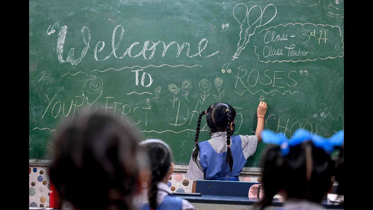  A girl draws on a board inside a classroom in New Delhi as schools reopen after months due to the Covid-19 pandemic. Pic/AFP