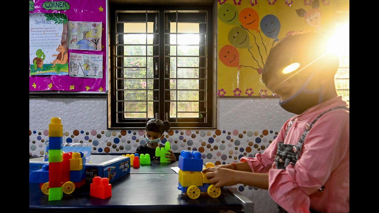 Children play inside a classroom in Delhi on Monday as schools reopen after 19 months. Pic/AFP