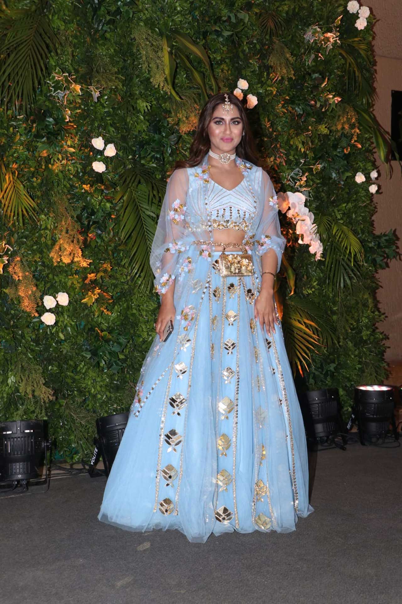 Close friend Krystle D'Souza wore a sky blue colored lehenga with silver and gold detailing. A metallic golden belt, maangtika and pearl choker completed her look. 