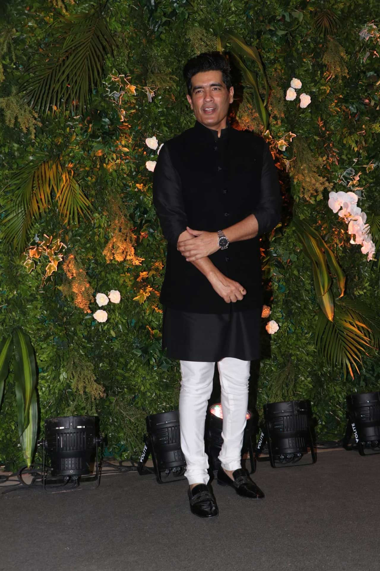 Manish Malhotra, who has designed the bride and groom's outfits, looked dapper in a black kurta and jacket, paired with white pants and black shoes.