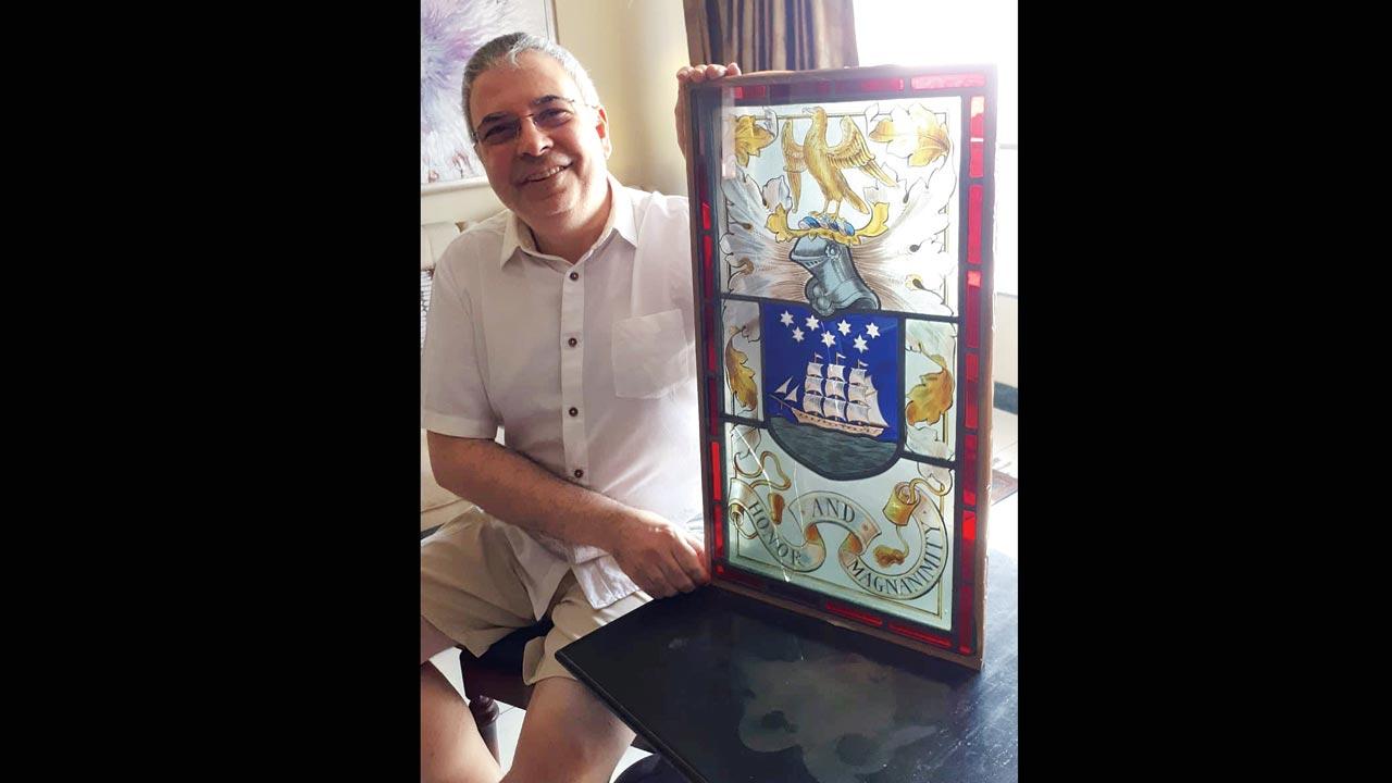 Grand-nephew Roy Wadia with the stained-glass window bearing the family crest (incorporating the famed ship emblem) from Lovji Castle