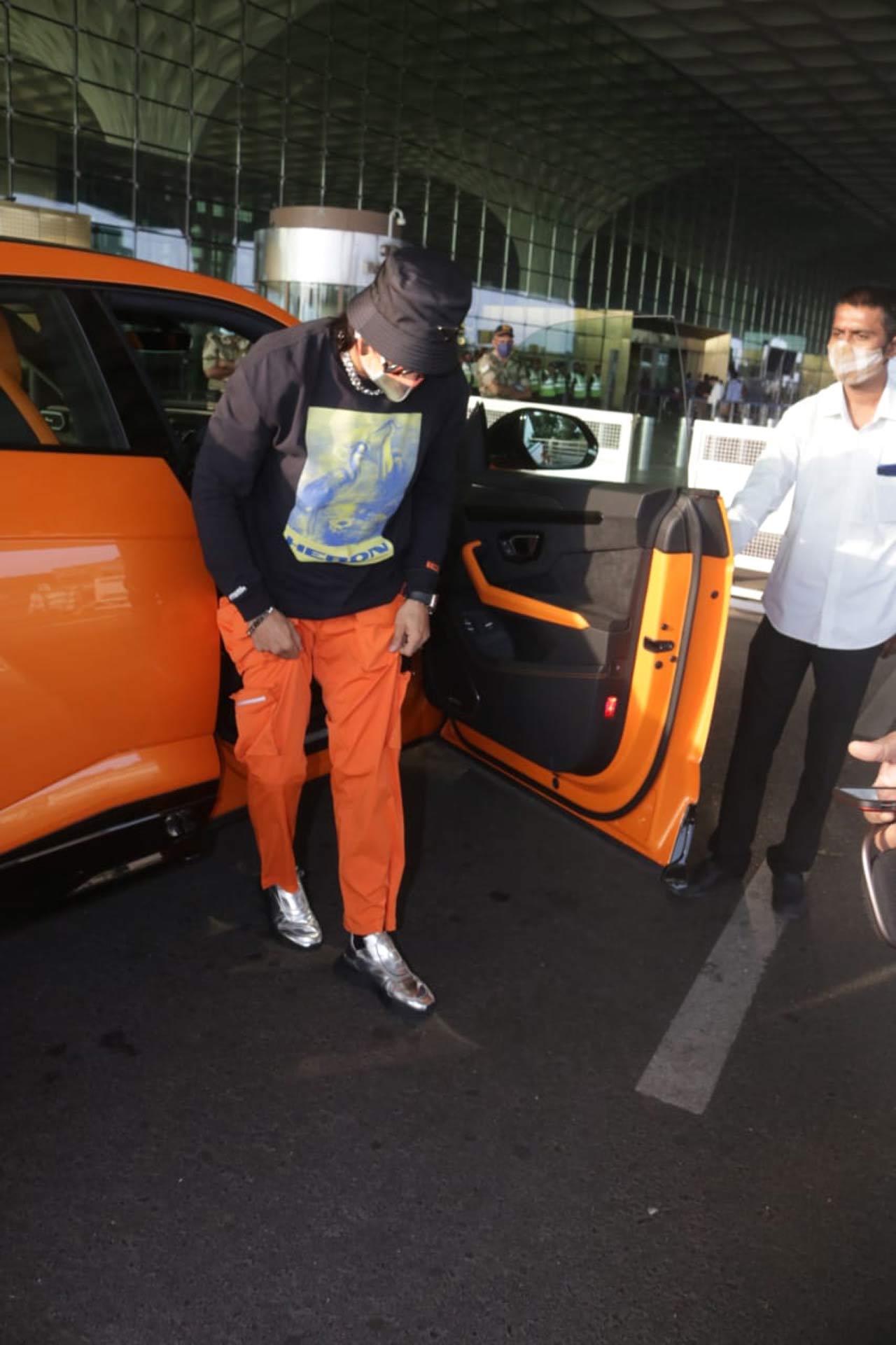 The actor complemented his customised orange Lamborghini with his 'whacky' fashion sense, which has taken the internet by storm. His last airport look, which highlighted two ponytails, was also a hit airport outing on social media.