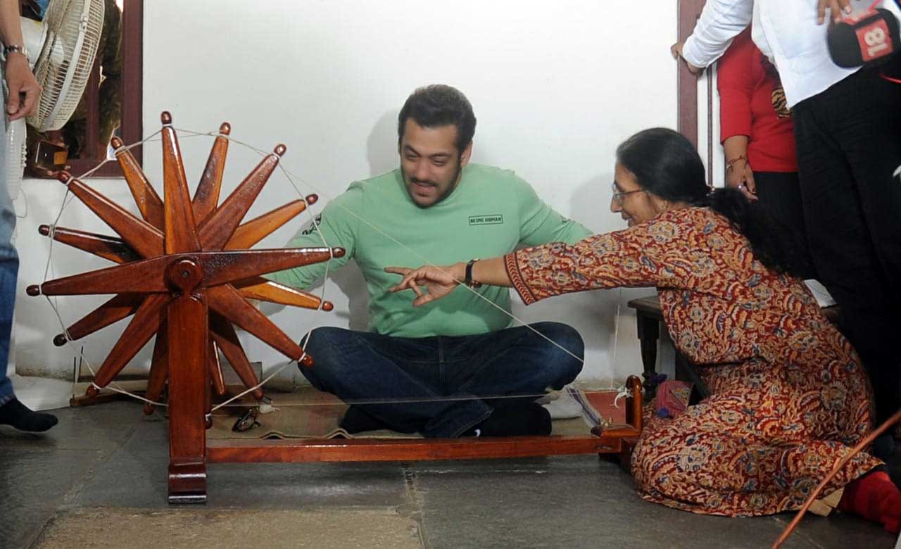The superstar looked dapper in jeans paired with a light green T-shirt. In the pictures obtained, the 'Dabangg' star can be seen sitting on the floor and observing how a charkha works. He then tries himself at spinning it.