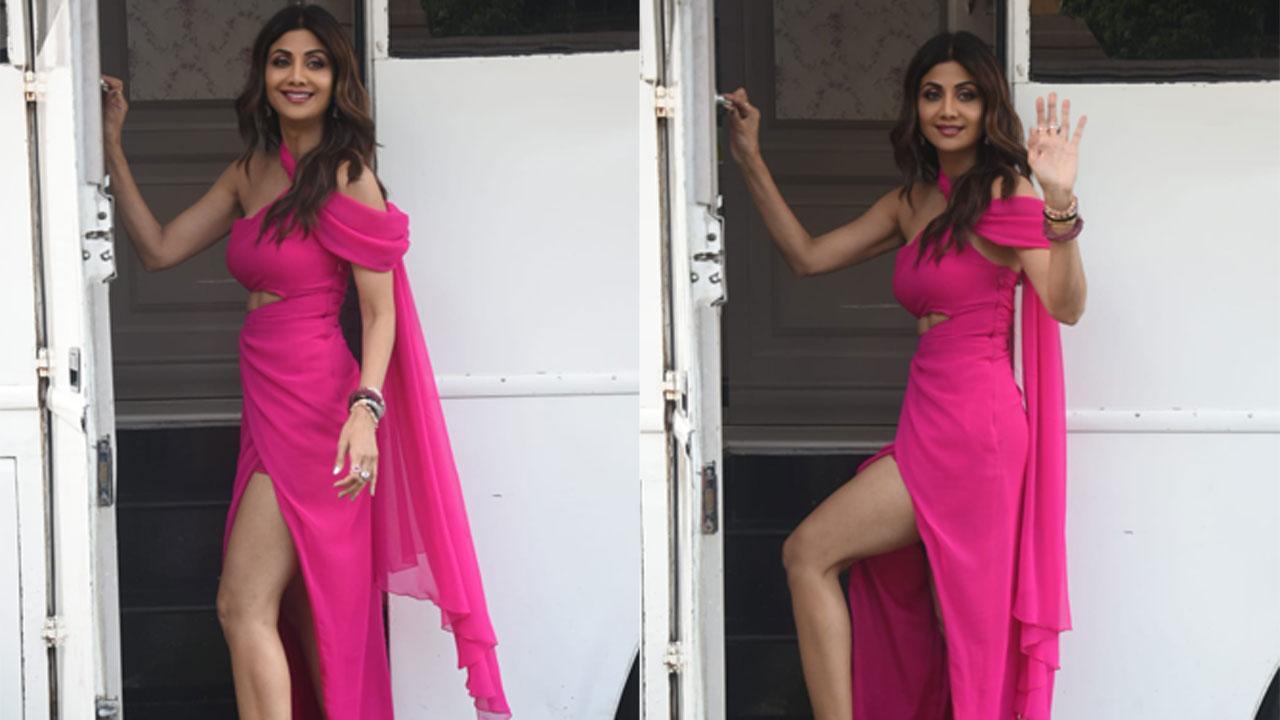 Shilpa Shetty was spotted shooting in a hot pink, cut out dress at a city studio on Thursday. The actress looked stunning as she posed in the high slit outfit with a train over one shoulder, teamed with kitten heels. Click here to see gallery