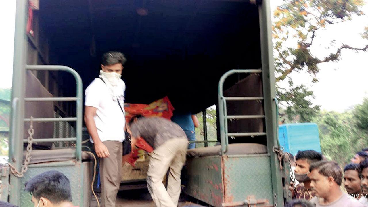 The cage being loaded onto a van