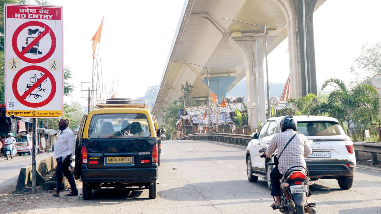A traffic cop stops a scooter rider on the BKC Connector