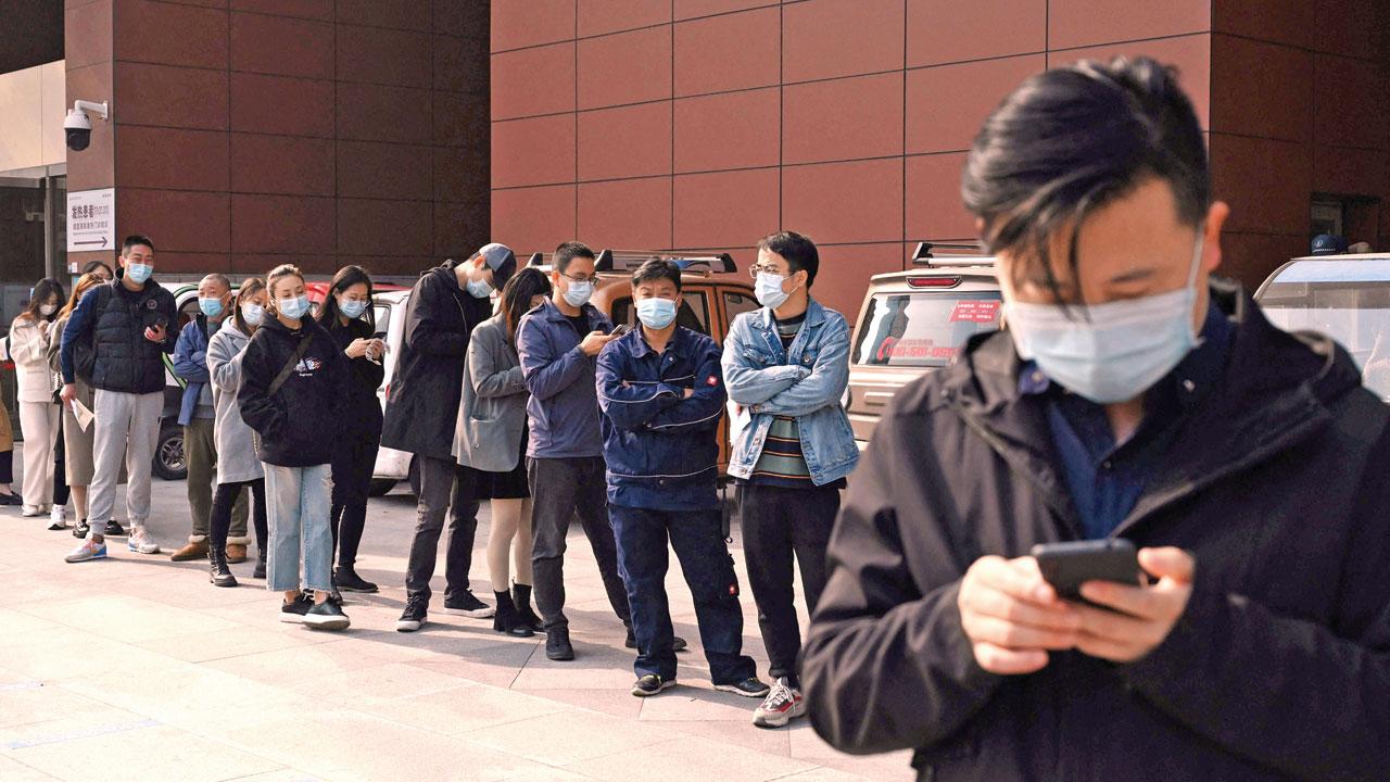 People line up to be tested for COVID-19 at a hospital in Beijing on Friday. Pic/AFP