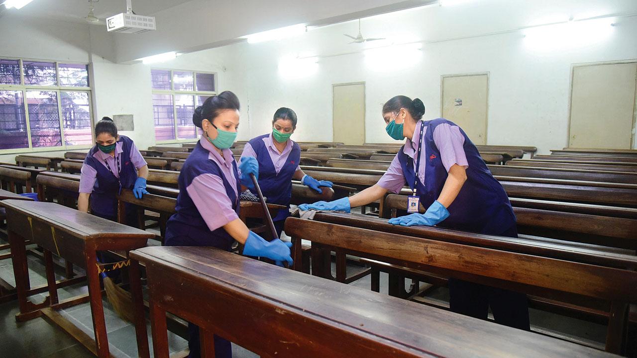 Workers sanitise a classroom at SIES College, Sion. File pic