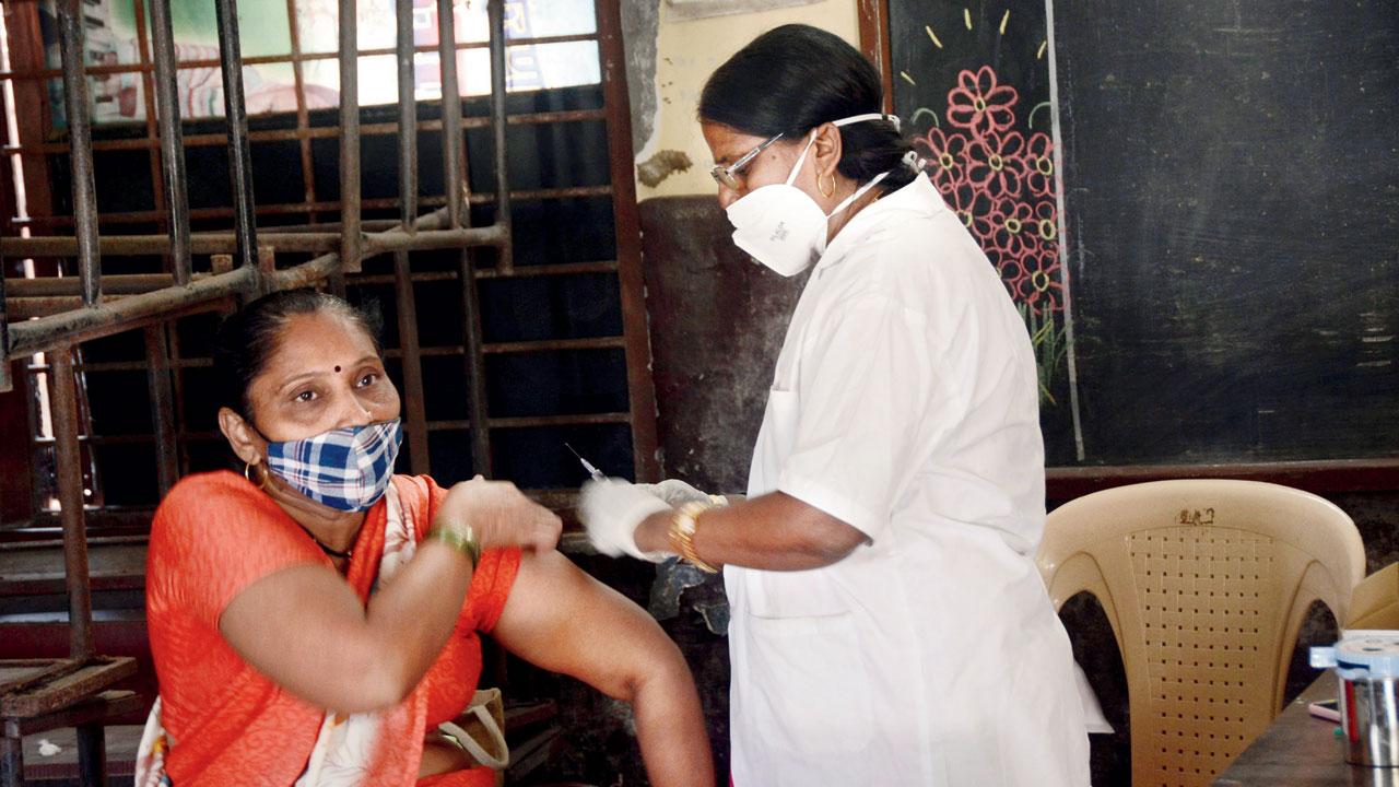 A woman gets a dose of Covid vaccine at Dr Babasaheb Ambedkar Primary School in Chembur. Pic/Sayyed Sameer Abedi