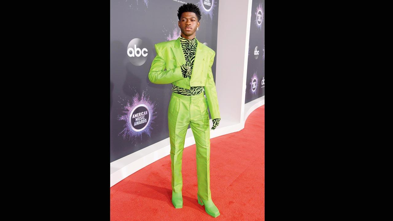 Lil Nas rocking a neon suit at a music awards show