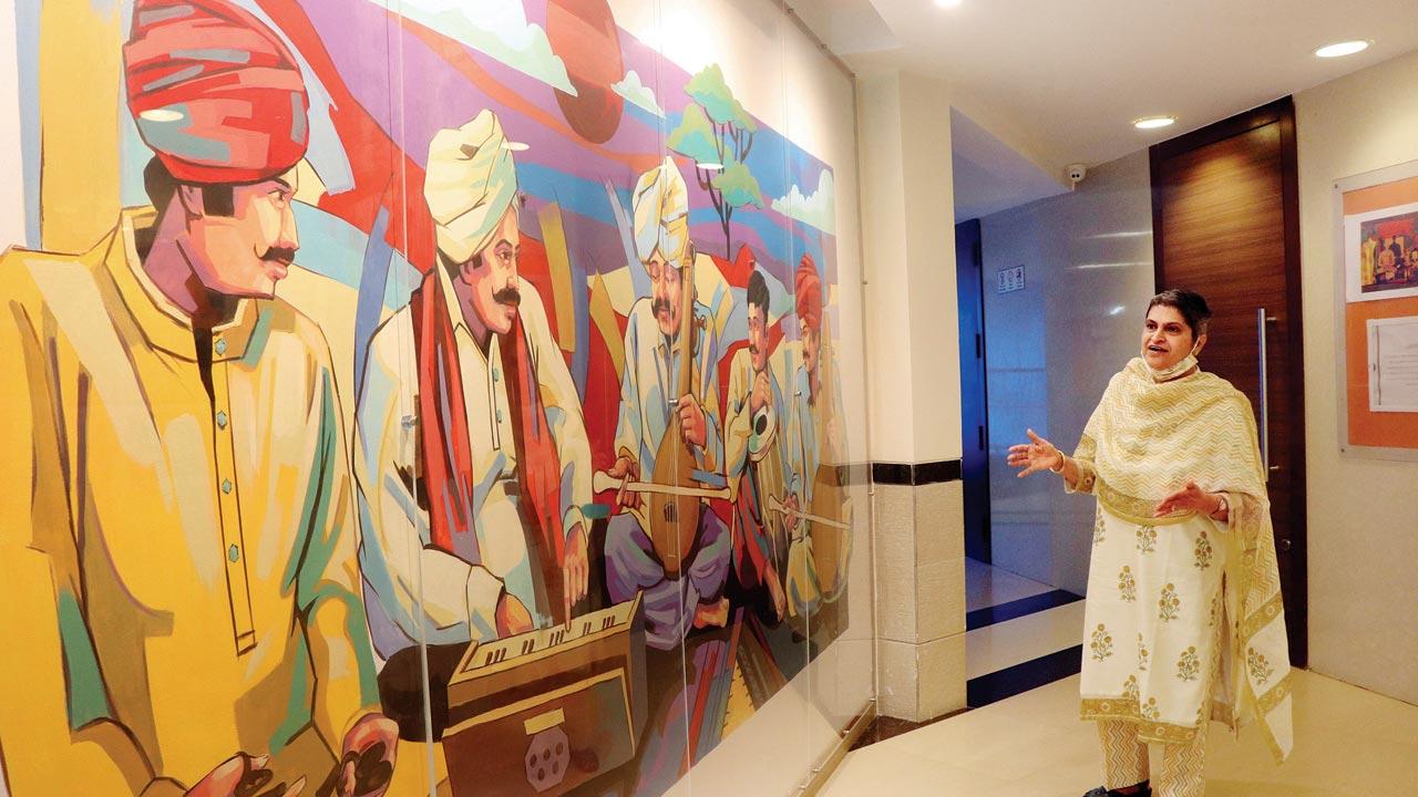 Zeenat Bhojaboy, principal, Jamnabai Narsee School, seen beside a wall showcasing a painting of Indian musicians. All the common areas have been repainted in bright colours to perk up the environment