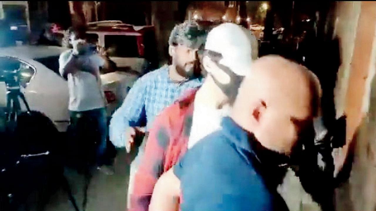 A grab of the video that shows K P Gosavi escorting Aryan Khan