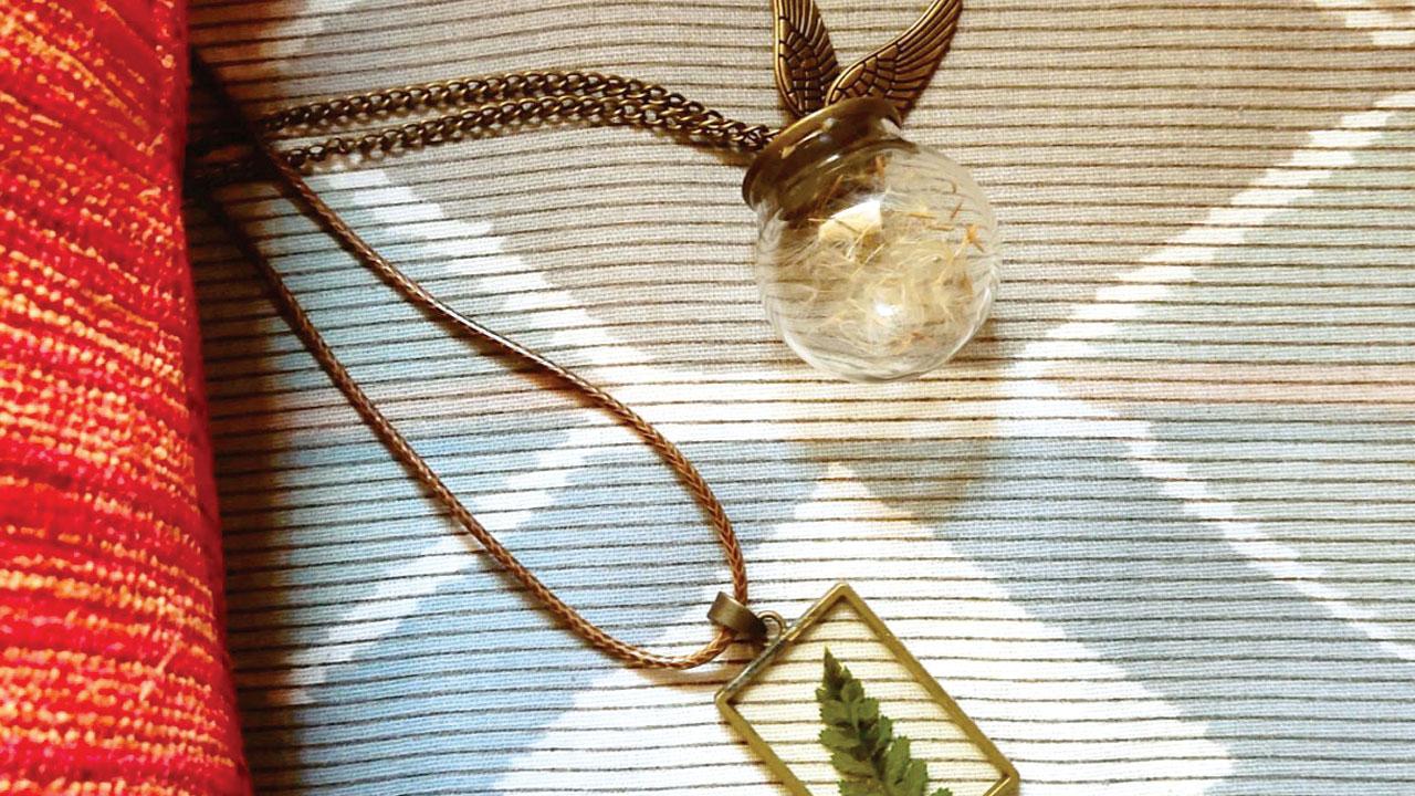 Conspicuous pea flower necklace (Rs 1,050) and potterhead Snitch dandelion seeds necklace (Rs 1,050)