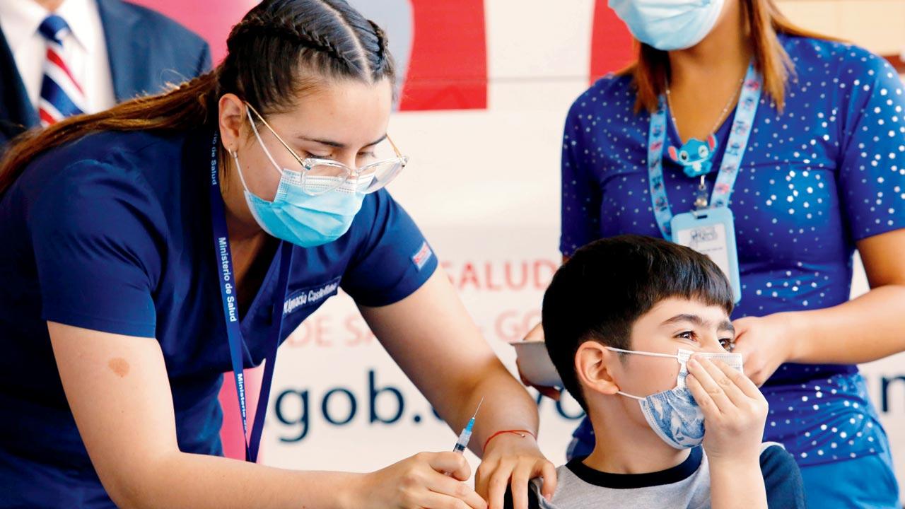 A health worker administers the first dose of Sinovac vaccine to a student as part of the immunisation plan against COVID-19 for children aged 6 to 11 at a school in Santiago, Chile. Pic/Getty Images