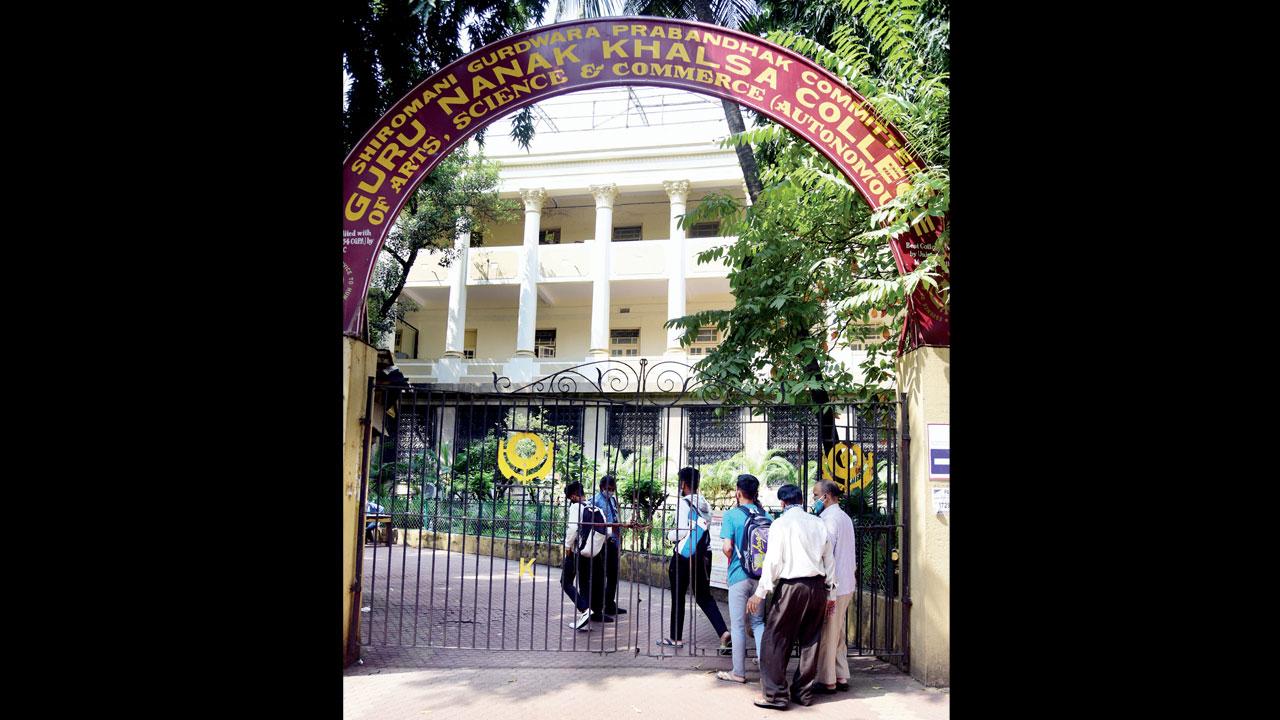 A group of friends sit and chat during a break at Khalsa college