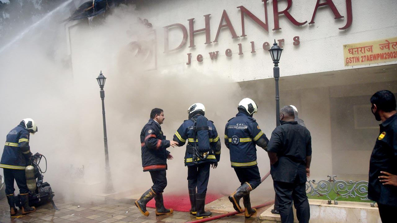 Fire brigade personnel try to control the fire at Dhanraj Jewellers on Waterfield Road, Bandra in July this year. File pic