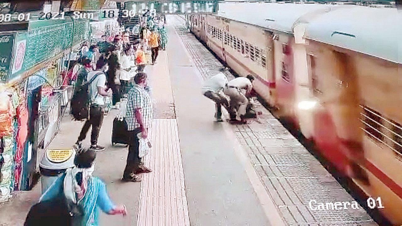 An RPF cop pulls a train traveller to safety in January this year