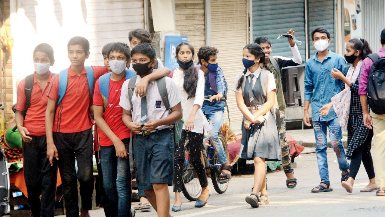 Students of Shri Vibhuti Narayan High School return home after the first day of classes, at Ashokvan, Dahisar, on October 4. Pic/Satej Shinde