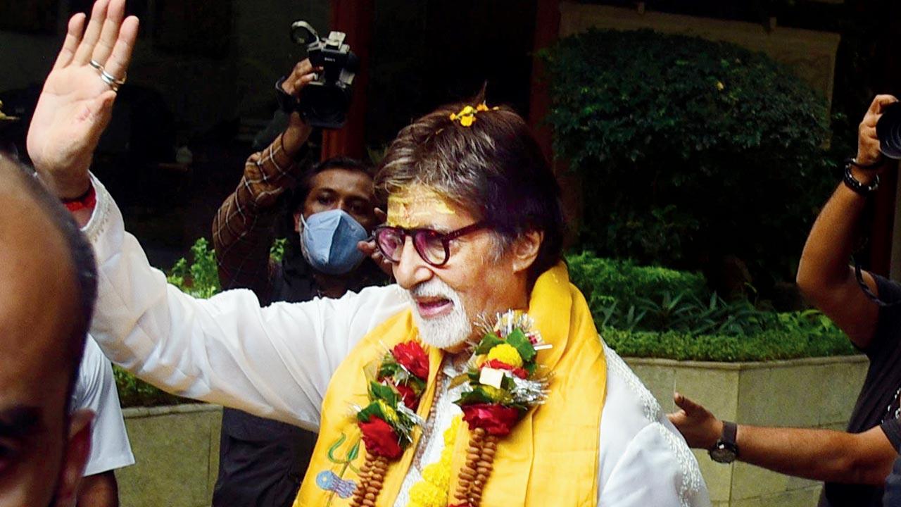 Bachchan waves out to his fans outside Jalsa on Monday. Pic/Shadab Khan