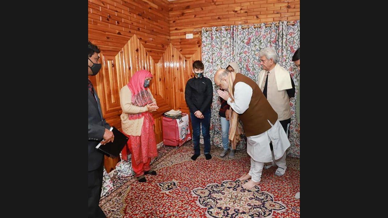 Amit Shah visiting the residence of martyr J&K Police, Inspector Parvez Ahmed who was killed by terrorists and met his wife Fatima Akhter in Nowgam. Pic/PTI