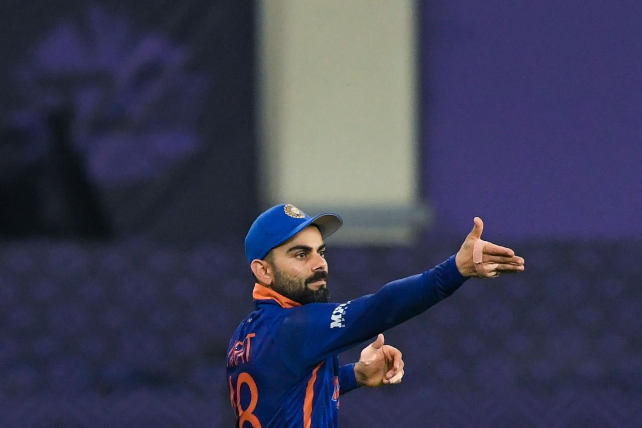 Virat Kohli adjusts the fielding positions during the ICC men’s Twenty20 World Cup cricket match between India and Pakistan at the Dubai International Cricket Stadium in Dubai