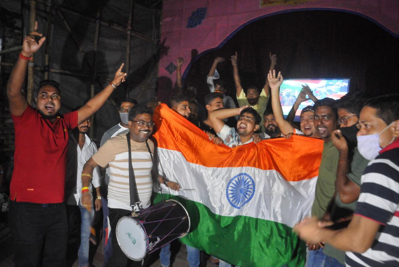 Cricket fans cheer while watching the World Cup T20 match of India and Pakistan on a big screen, in Kolkata, Sunday, Oct. 24, 2021