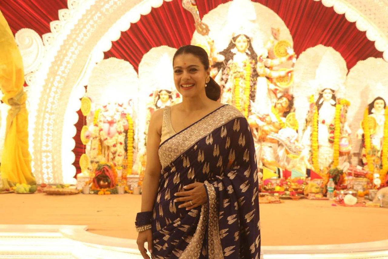 Kajol was all smiles as she  posed for the paparazzi. She opted for a beautiful nine-yard for Maha Ashtami pooja on Navratri. (Pic: Pallav Paliwal)