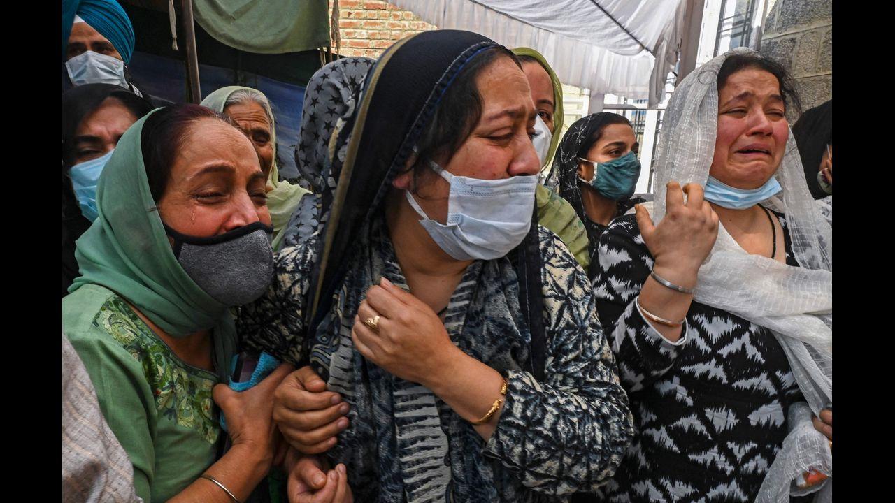 Relatives of slain government school principal Supinder Kour mourns during a funeral procession in Srinagar. Pic/AFP
