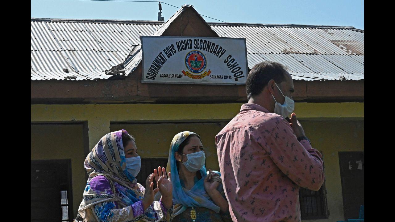 Teachers stand inside a government-run school on the outskirts of Srinagar, after suspected anti-India militants shot dead two schoolteachers in Indian-administered Kashmir, police said. Pic/AFP