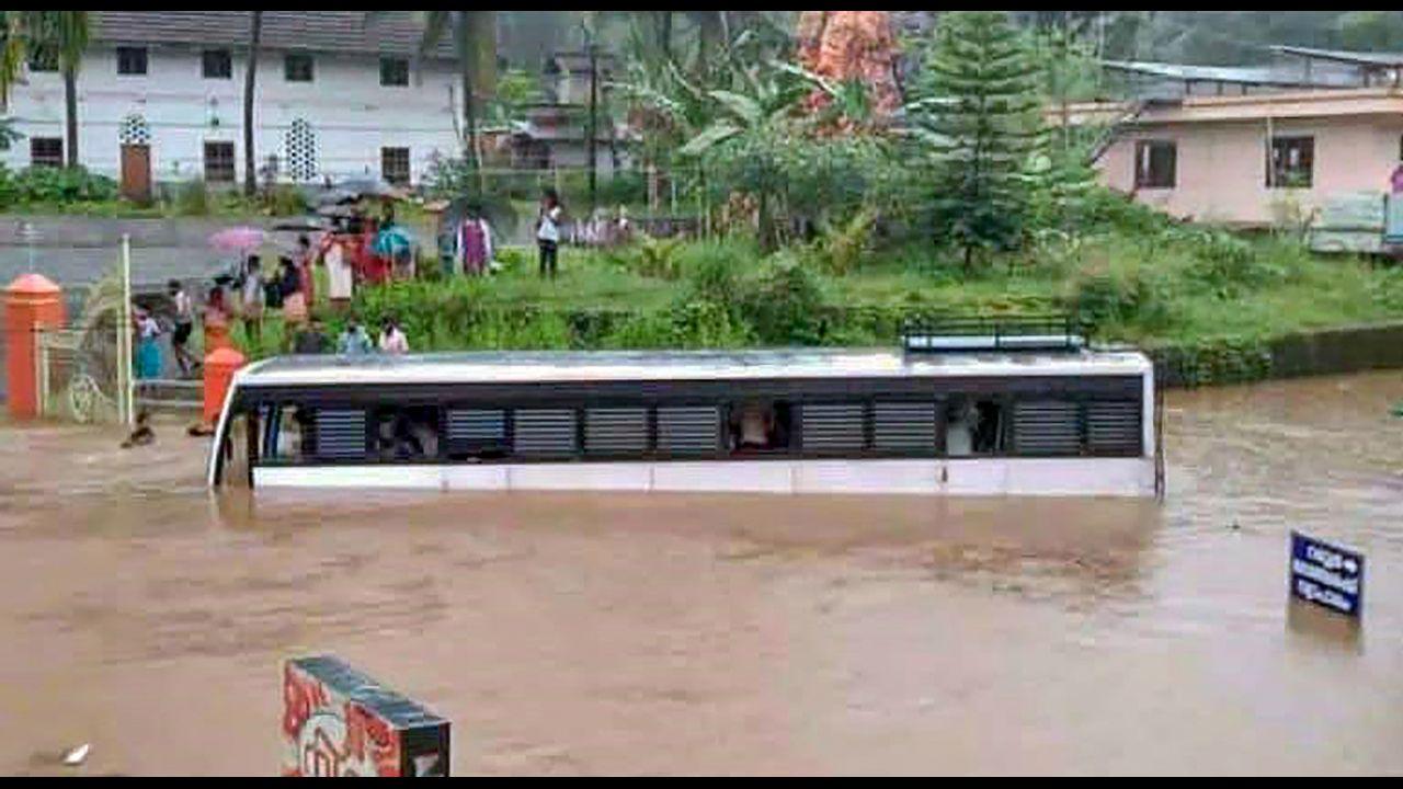 A bus partially submerged in a waterlogged area following heavy rains at Poonjaar in Kottayam. Pic/PTI