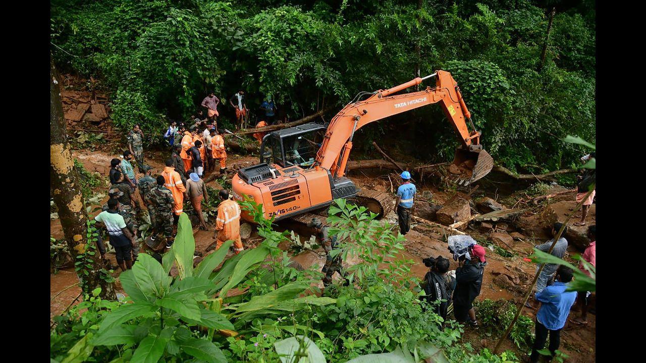 Rapid Action Force (RAF) and Kerala Fire and Rescue personnel during rescue operations at the site of landslide at Kavali in Kottayam district. Pic/PTI