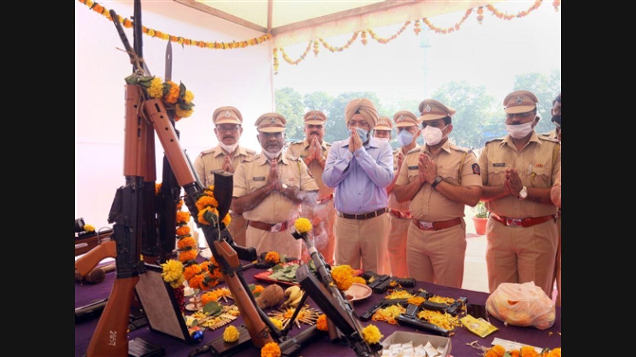 Police officers perform 'Shastra Pooja' on the occasion of Dussehra in Thane. Pic/PTI