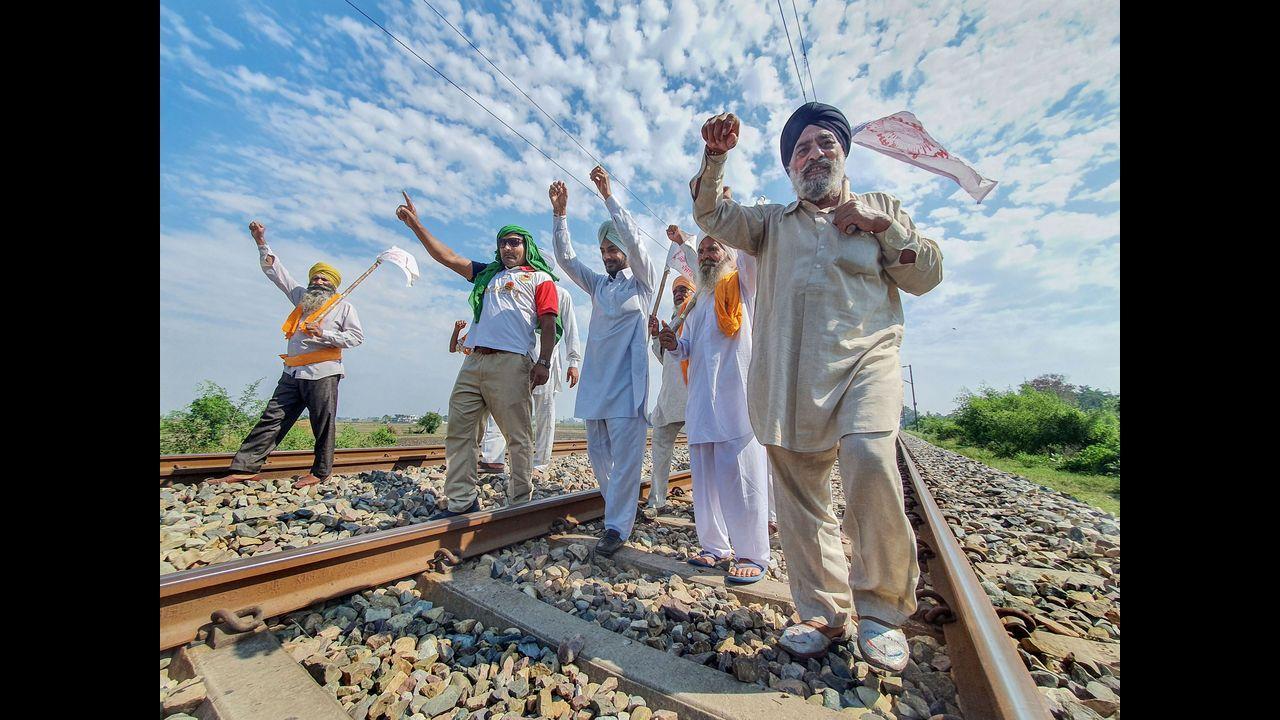 Farmers block railway tracks as part of the Samyukt Kisan Morcha's 'rail roko' protest demanding the dismissal of Ajay Mishra in connection with violence in Lakhimpur Kheri. Pic/PTI