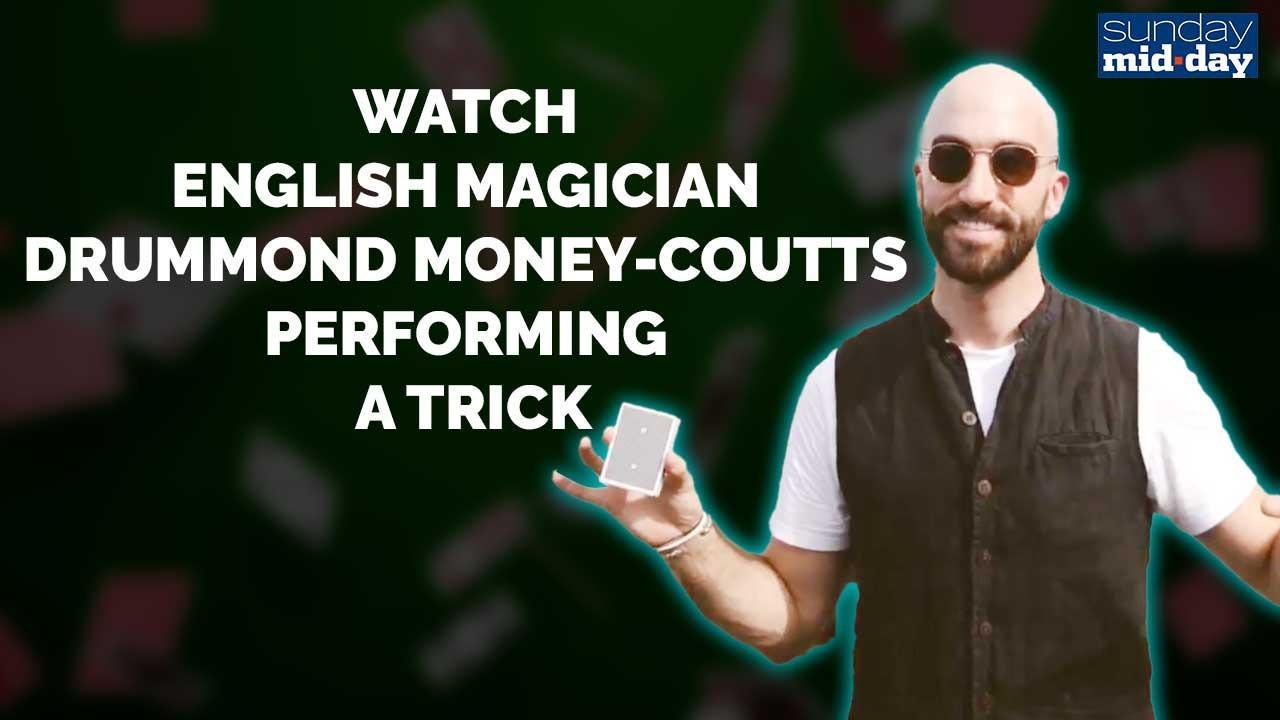 English magician Drummond Money-Coutts performing a trick
