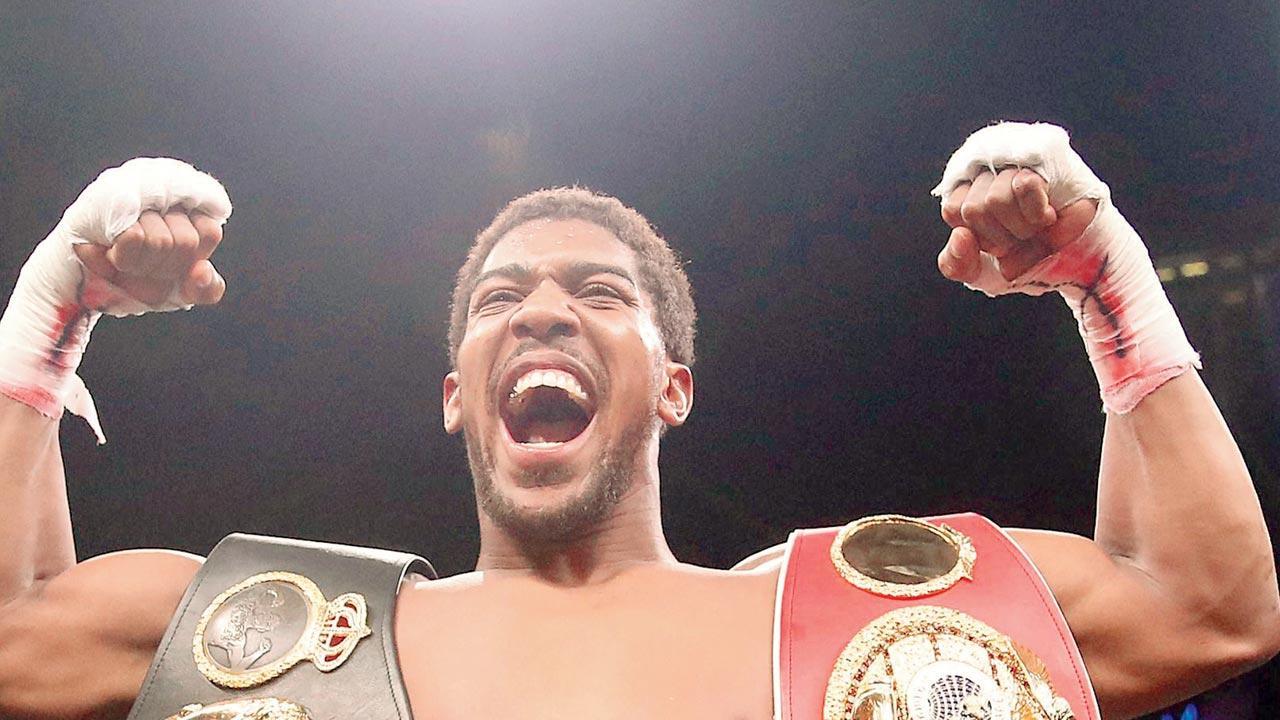 Boxer Joshua weighs in 19 pounds heavier than opponent Usyk