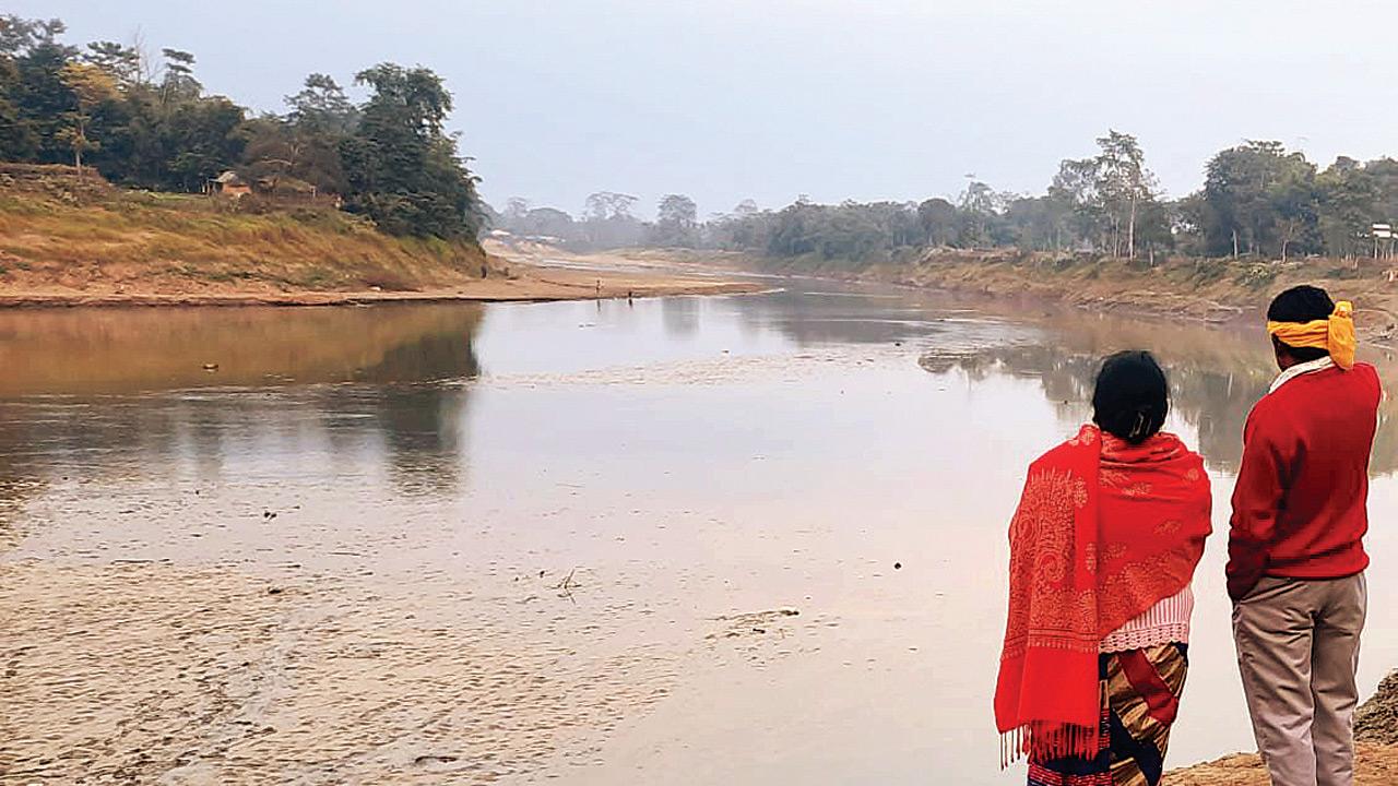 Community leader Bhadra Rajwar and his wife living in Nazira near Dikhow river, a tributary of the Brahmaputra, look at their eroded land