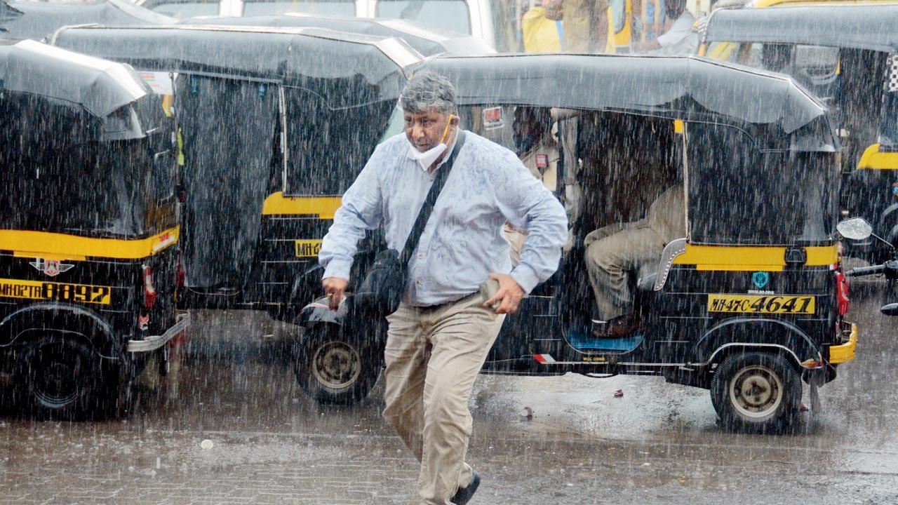 A man runs to escape heavy showers in Borivli on Wednesday. Pic/Satej Shinde